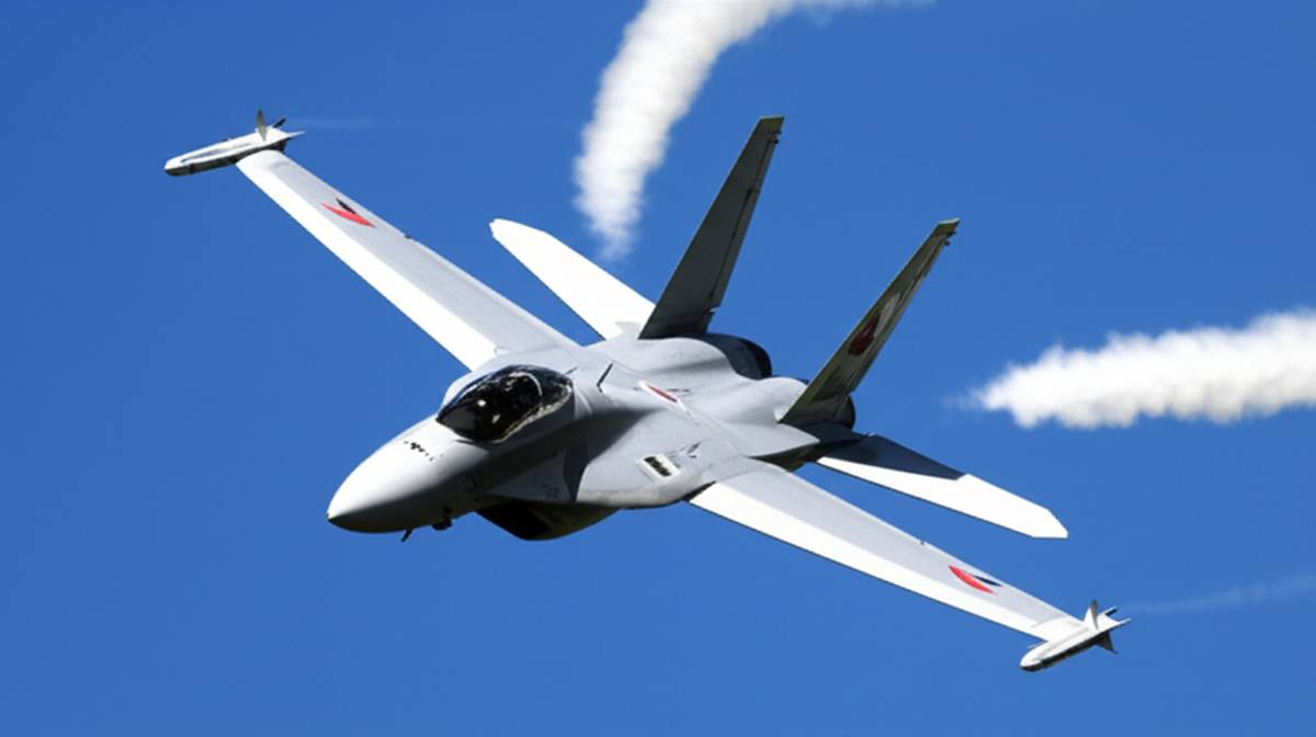 Fighter jet in flight with contrails, symbolizing air power and defense spending.